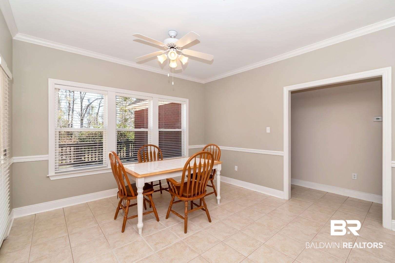 6090 Celeste Road Saraland, AL 36571 - Photo 14 of 38 Dining room featuring baseboards, crown molding, and ceiling fan