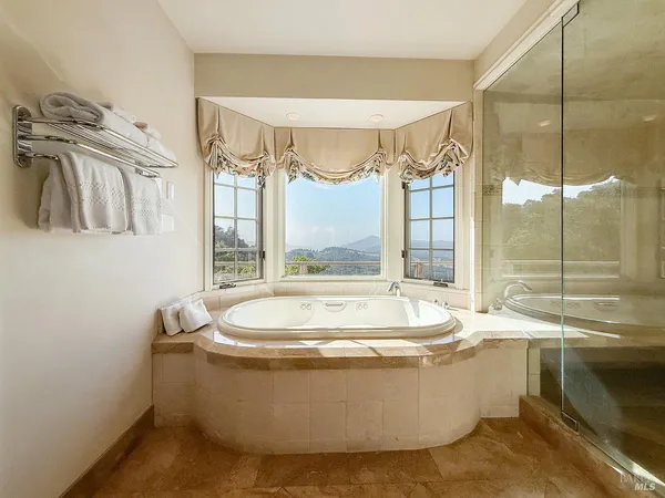 a spacious bedroom with a bed a couch and dresser