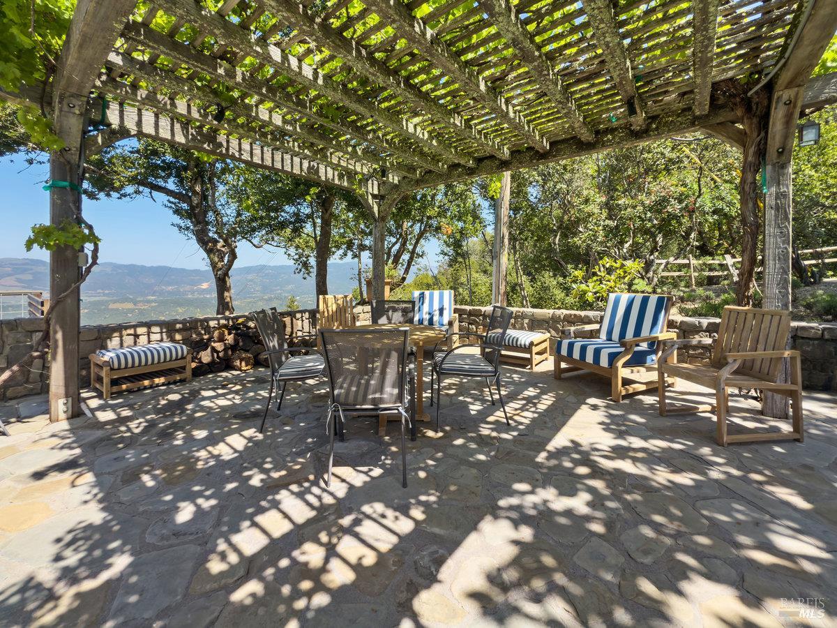 1000 Wolf Ridge Road Glen Ellen, CA 95442 - Photo 48 of 70 a view of a patio with table and chairs potted plants and large tree