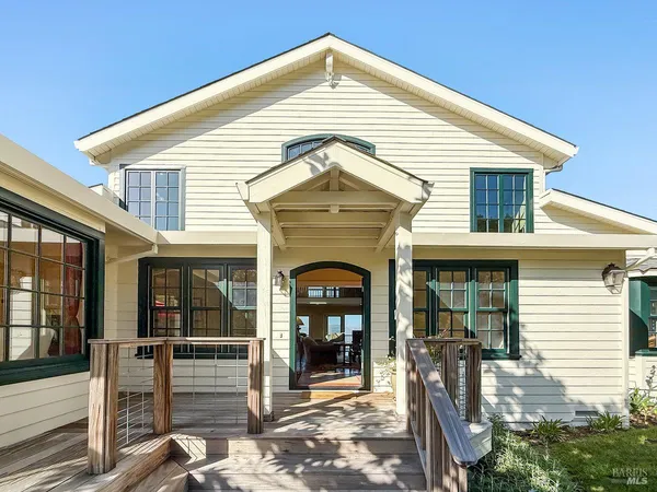 a living room with lots of furniture and a view of kitchen