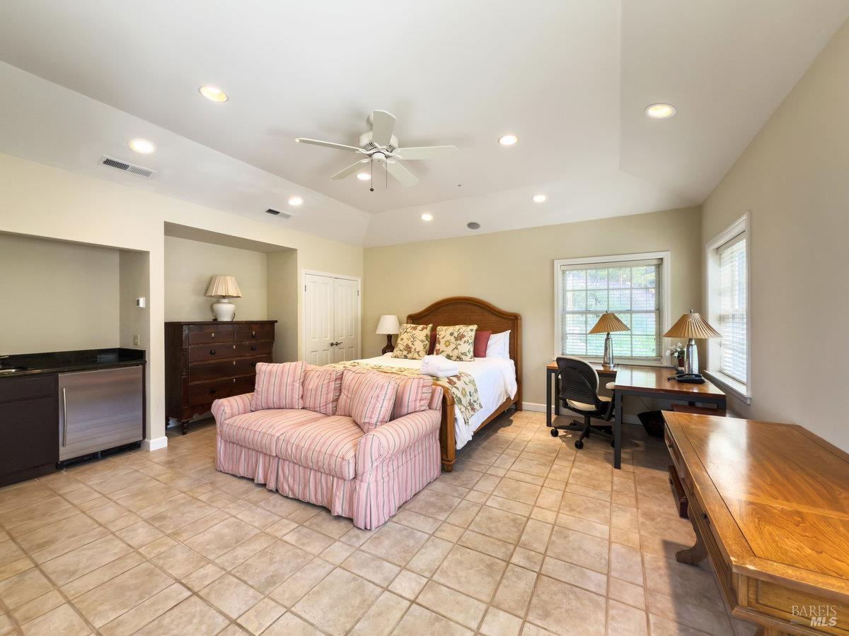 1000 Wolf Ridge Road Glen Ellen, CA 95442 - Photo 60 of 70 a spacious bedroom with a bed a couch and dresser