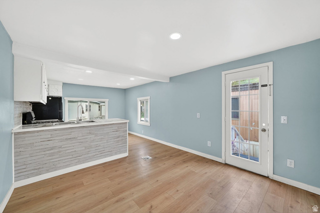 200 North Harrisville Road, Unit 37 Ogden, UT 84404 - Photo 2 of 14 Kitchen featuring white cabinetry, a peninsula, light wood-type flooring, recessed lighting, and stainless steel range with gas stovetop