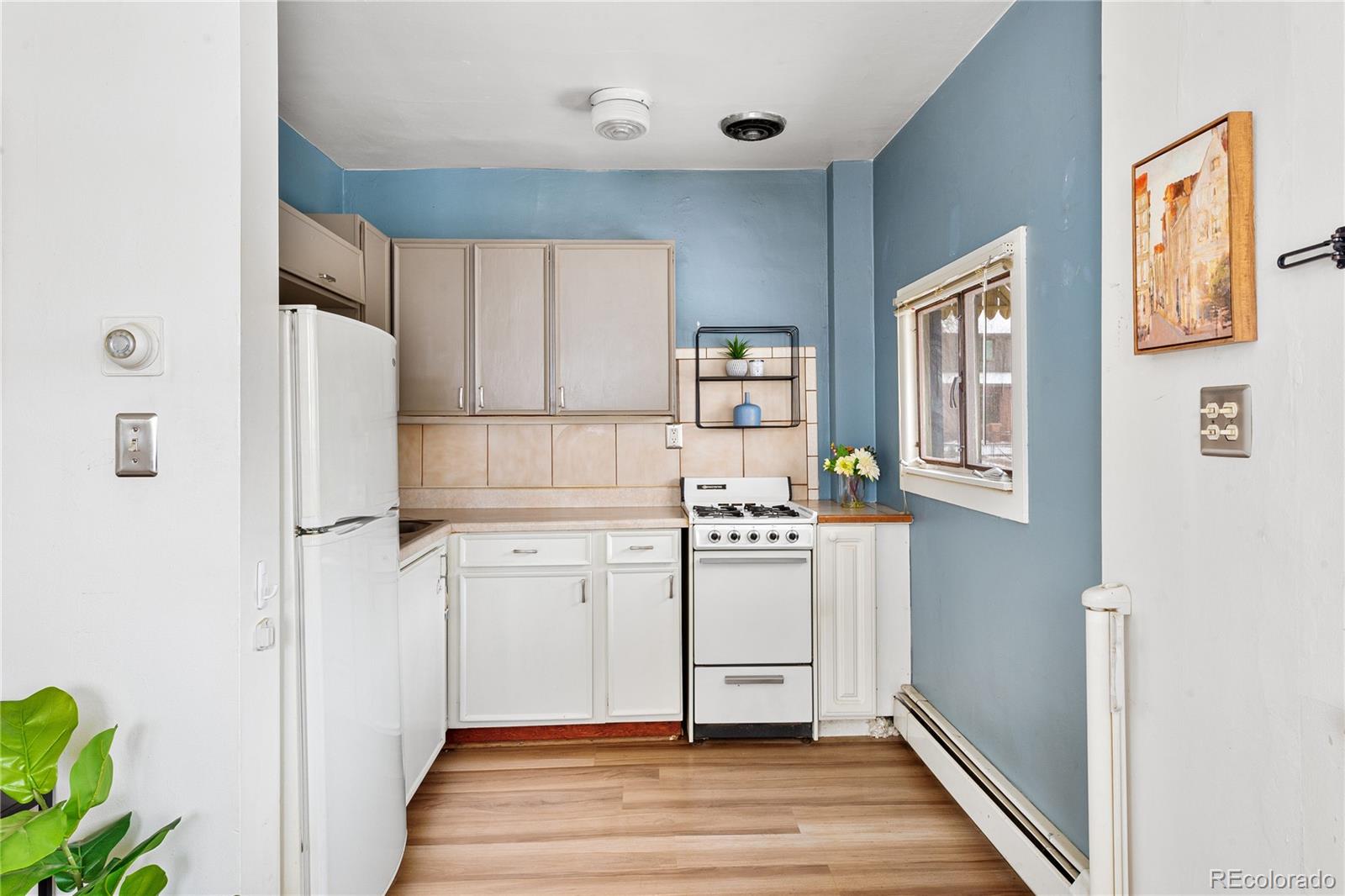 4151 Zenobia Street Denver, CO 80212 - Photo 15 of 31 a kitchen with stainless steel appliances a refrigerator and a stove