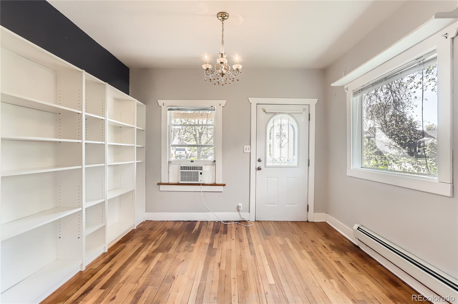 4151 Zenobia Street Denver, CO 80212 - Photo 22 of 31 a view of an empty room with a window and wooden floor
