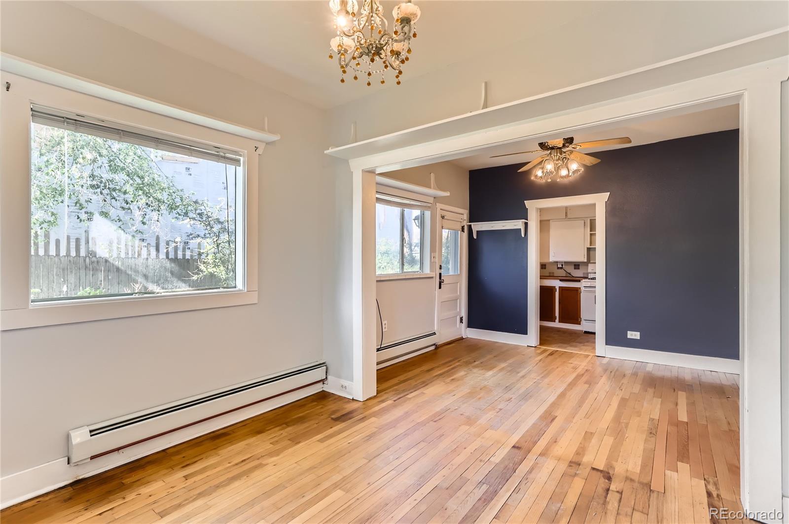 4151 Zenobia Street Denver, CO 80212 - Photo 24 of 31 a view of an empty room with window and wooden floor