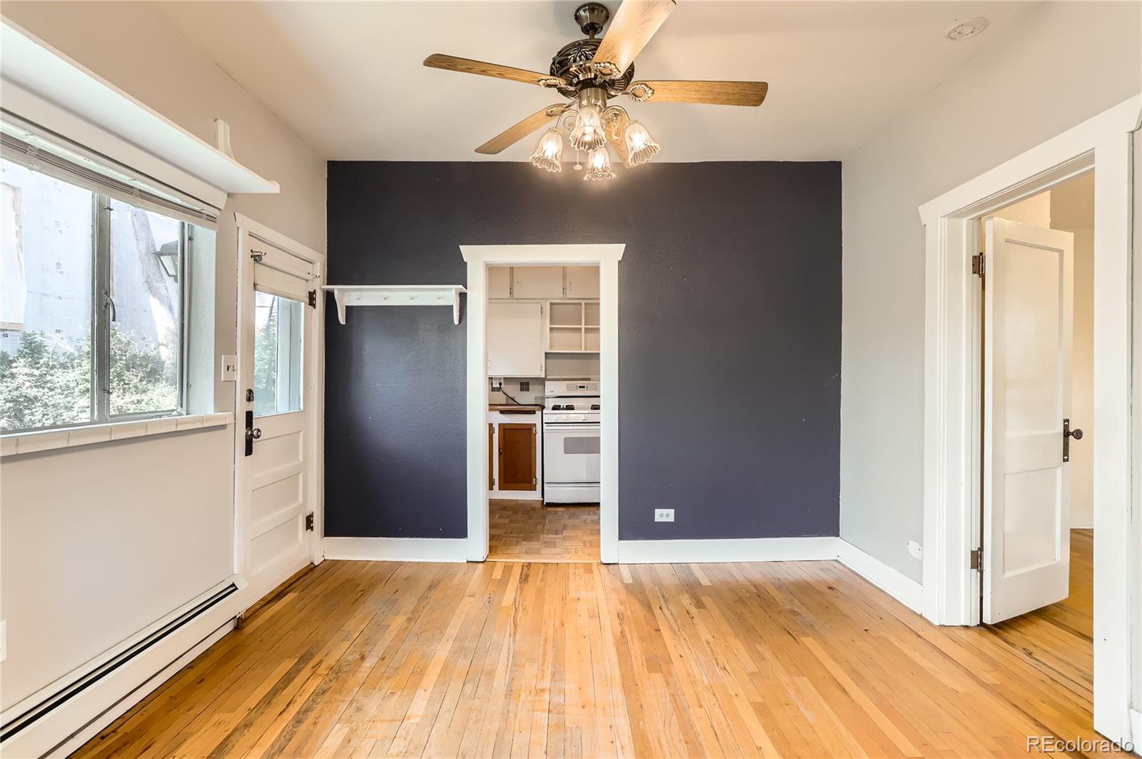 4151 Zenobia Street Denver, CO 80212 - Photo 25 of 31 a view of an empty room with window and wooden floor