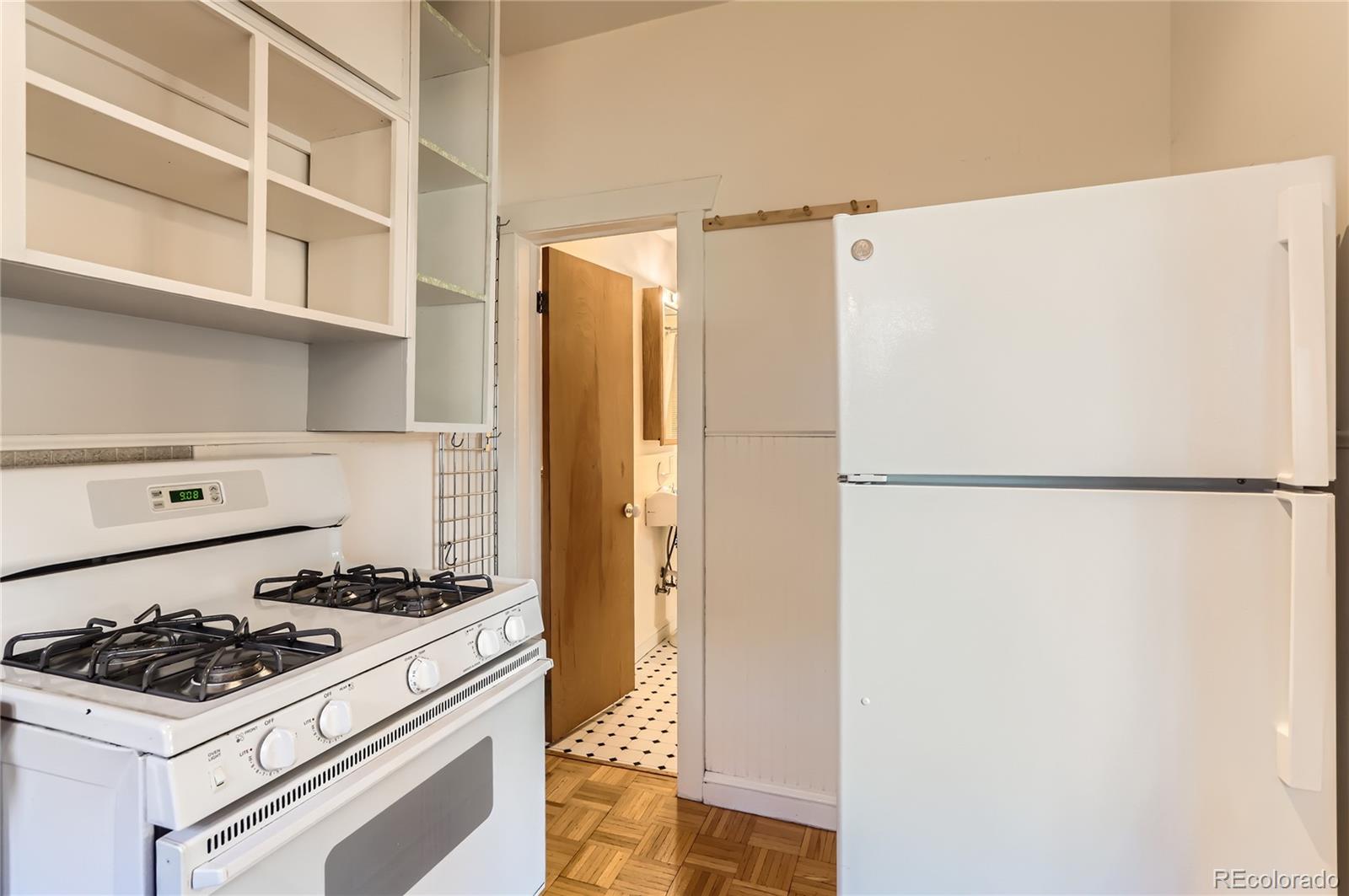 4151 Zenobia Street Denver, CO 80212 - Photo 28 of 31 a kitchen with a refrigerator and a stove