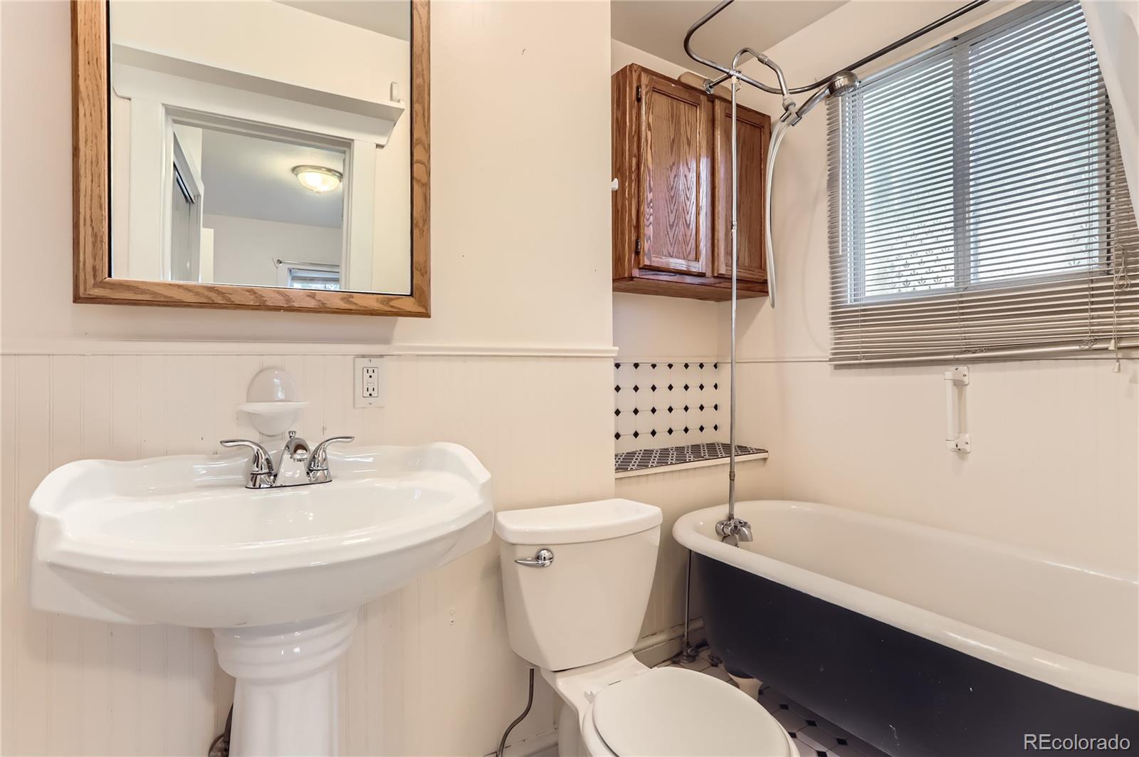 4151 Zenobia Street Denver, CO 80212 - Photo 31 of 31 a bathroom with a sink a toilet and mirror