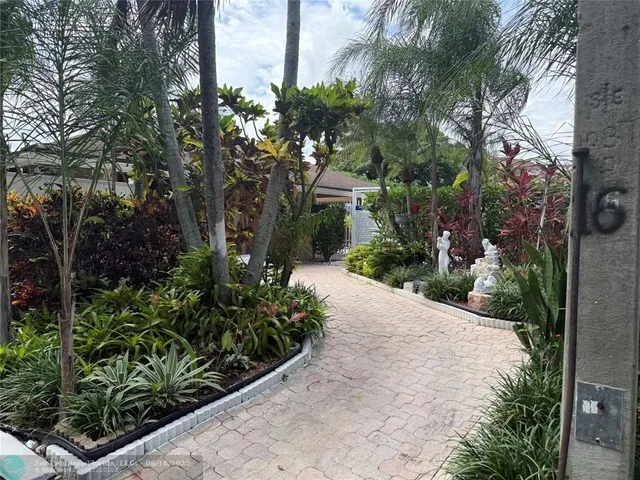 a view of a patio with a table and chairs under an umbrella