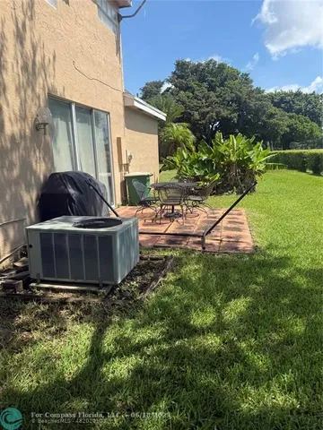 a view of a patio with table and chairs and potted plants