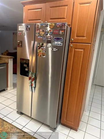 a kitchen with stainless steel appliances granite countertop a sink a stove a microwave a dining table and chairs