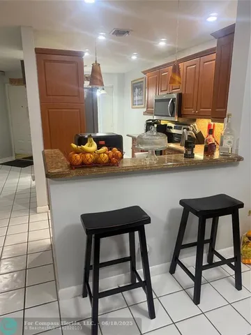 a living room with furniture a rug and a flat screen tv