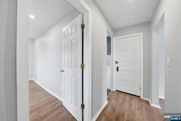 a view of a livingroom with a window wooden floor and a ceiling fan