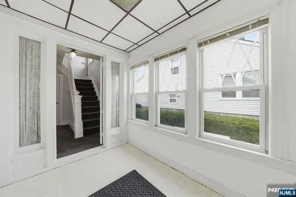 a view of a livingroom with wooden floor and a window