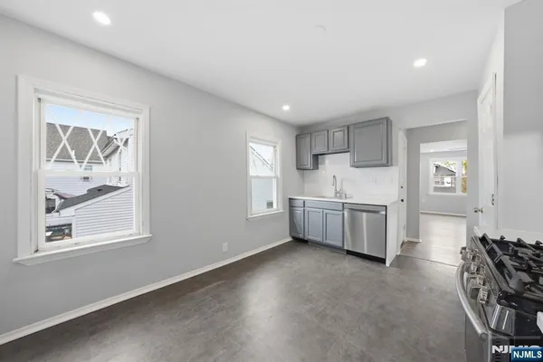 a kitchen with stainless steel appliances granite countertop a stove and a refrigerator