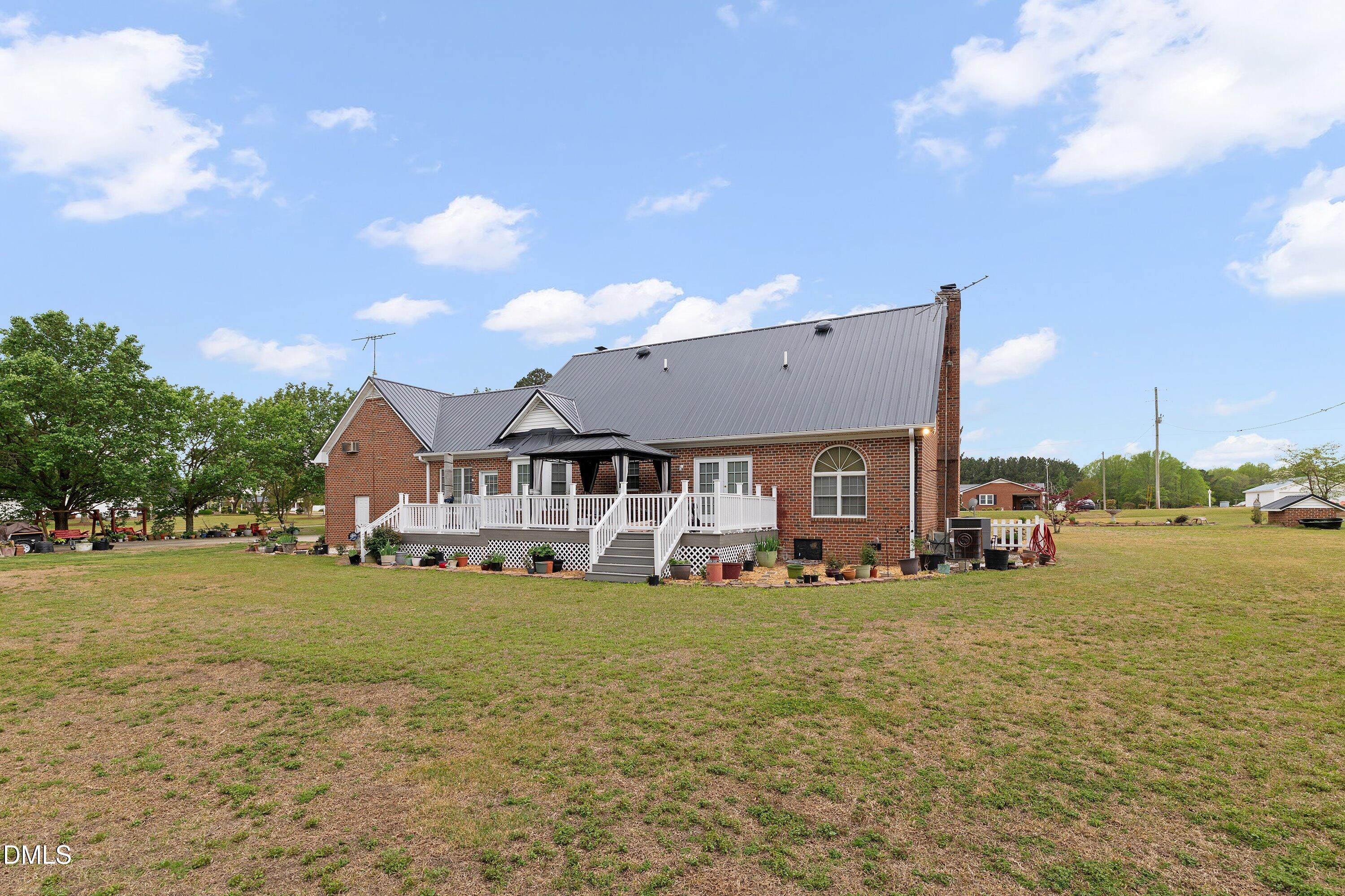 6314 Old Davis Road Sims, NC 27880 - Photo 54 of 71 a view of a house with a big yard and large trees