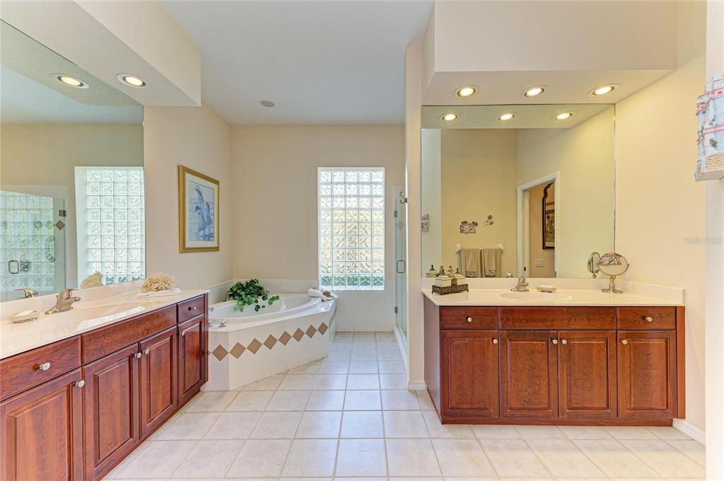 8122 Waterview Boulevard Lakewood Ranch, FL 34202 - Photo 29 of 54 a spacious bathroom with a granite countertop double vanity sink a mirror and a bathtub