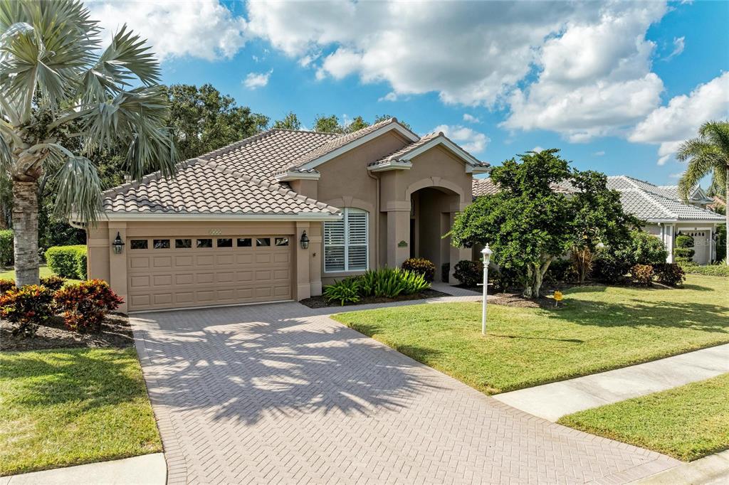 8122 Waterview Boulevard Lakewood Ranch, FL 34202 - Photo 3 of 54 a front view of a house with a yard and garage