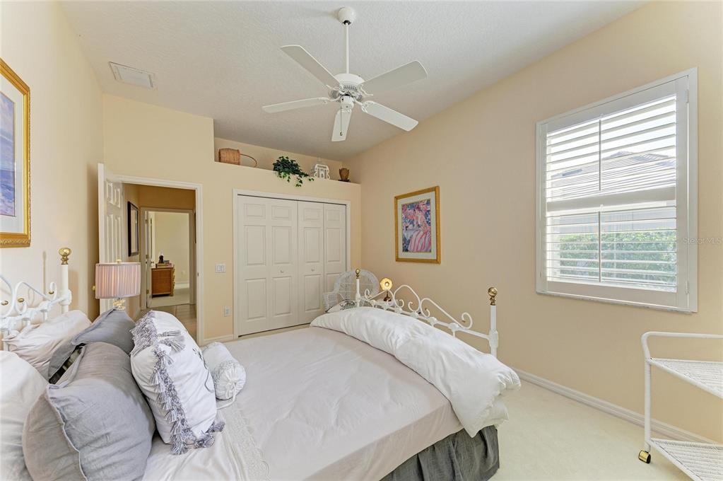8122 Waterview Boulevard Lakewood Ranch, FL 34202 - Photo 33 of 54 a bedroom with a bed and a window