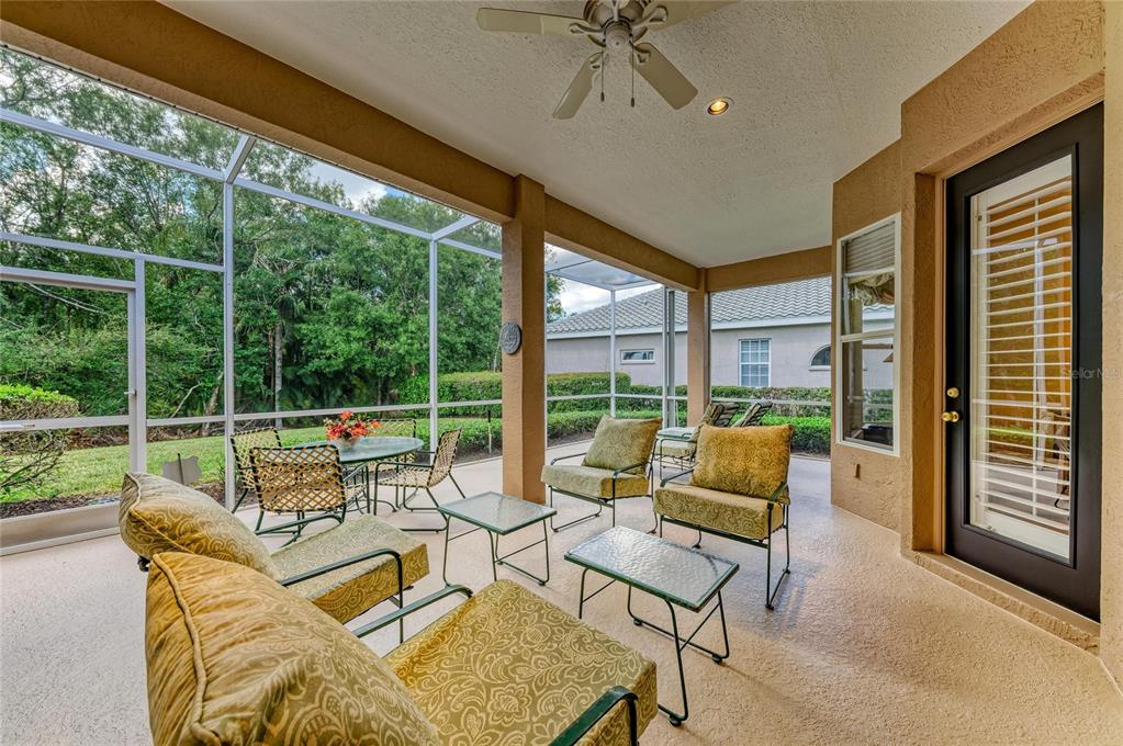 8122 Waterview Boulevard Lakewood Ranch, FL 34202 - Photo 39 of 54 a living room with furniture and floor to ceiling windows