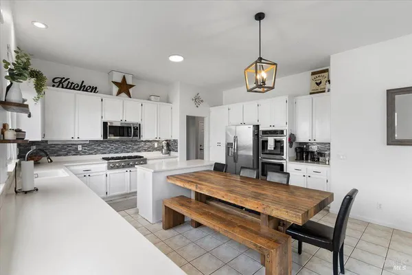 a kitchen with stainless steel appliances granite countertop a stove refrigerator and cabinets