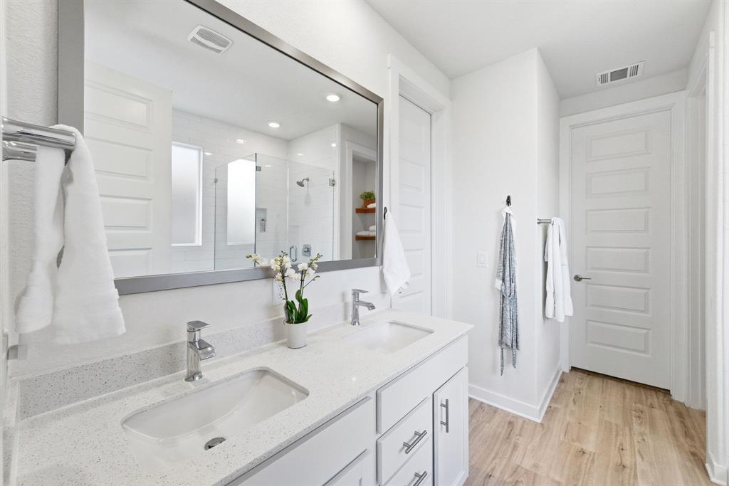 4420 Ingram Road Georgetown, TX 78628 - Photo 16 of 40 Clean lines and a spacious dual vanity define this modern, light-filled bathroom.