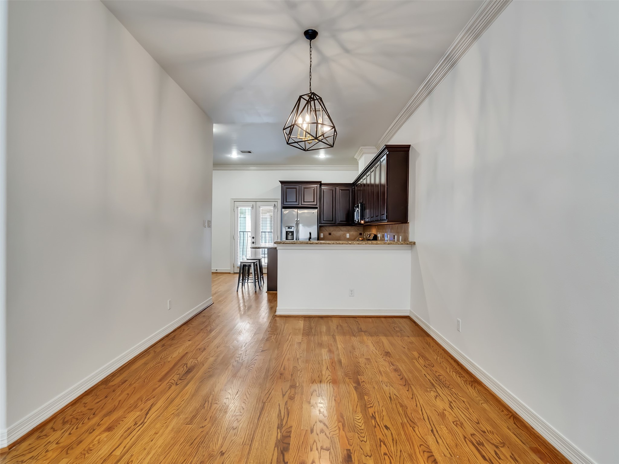 2540 Prospect Street, Unit B Houston, TX 77004 - Photo 15 of 37 a view of a room with wooden floor a kitchen view and a window