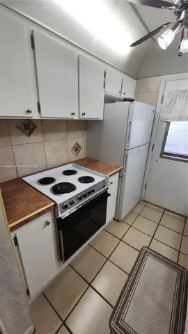a stove top oven sitting inside of a kitchen