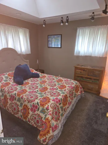 a bedroom with a bed and lamp with window