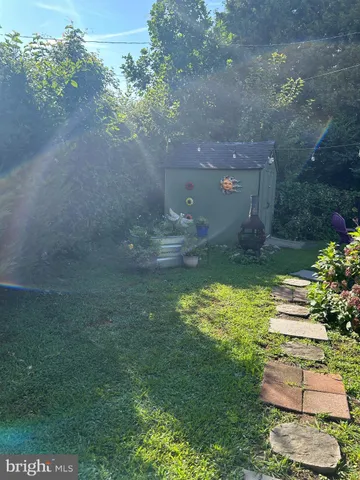 a backyard of a house with lots of green space and outdoor seating