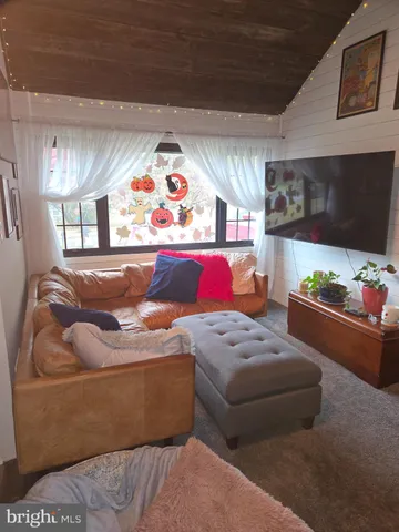 a living room with furniture flowerpot and window