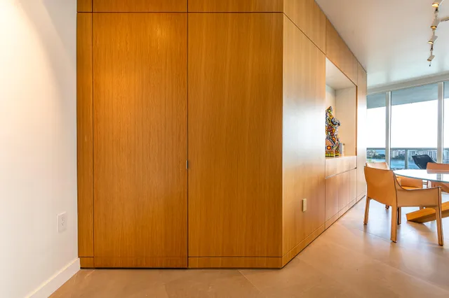 a view of a living room hardwood floor and a large window