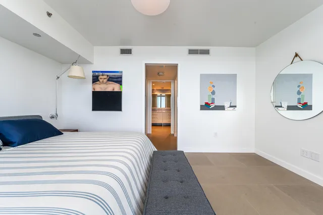 a bedroom with a bed and a dresser