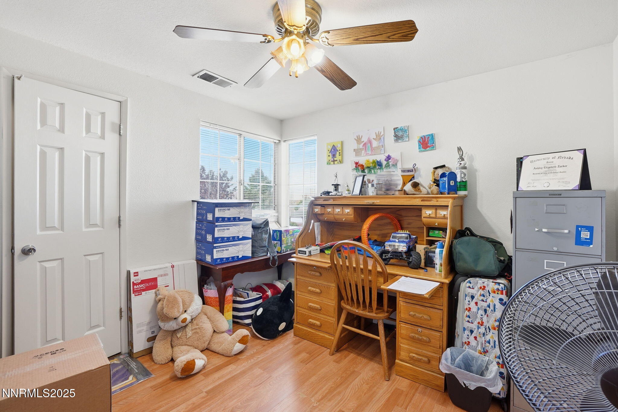 8486 Piper Place Reno, NV 89506 - Photo 17 of 25 a bedroom with furniture and a wooden floor