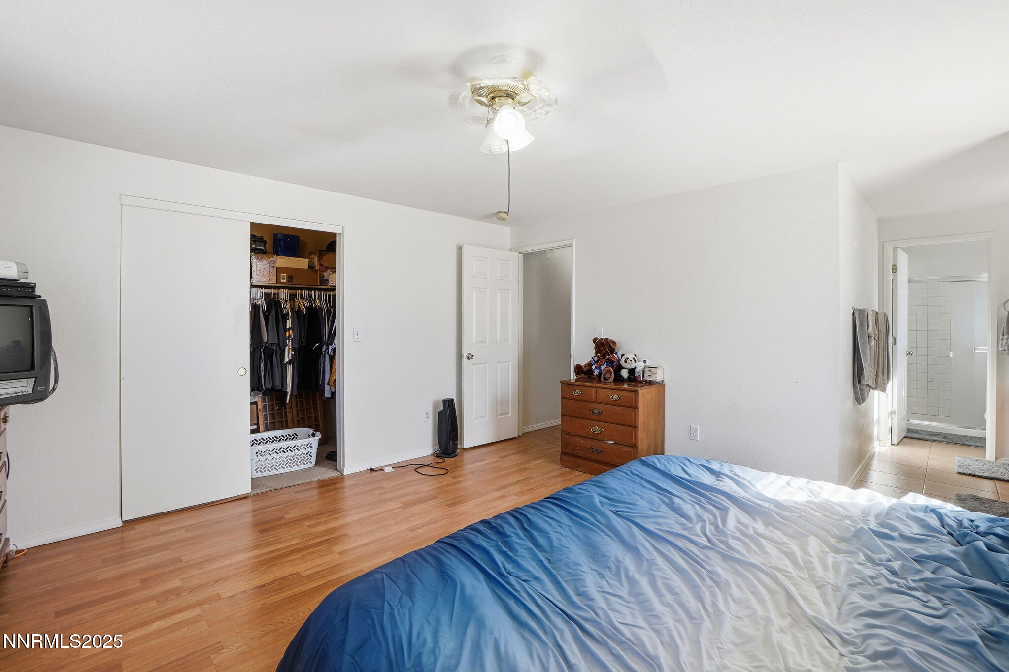 8486 Piper Place Reno, NV 89506 - Photo 20 of 25 a bedroom with a bed and a chandelier