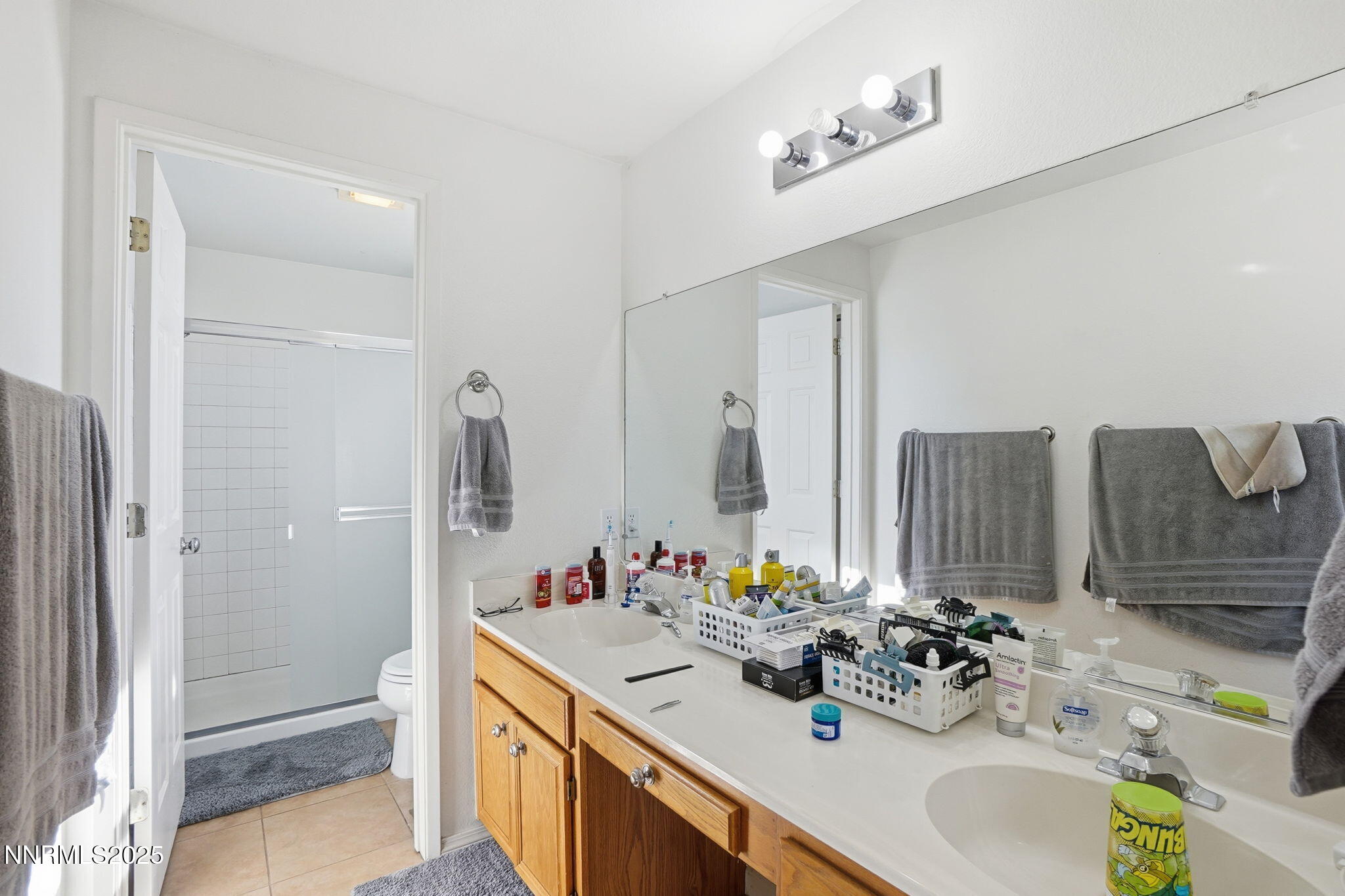 8486 Piper Place Reno, NV 89506 - Photo 22 of 25 a bathroom with a sink double vanity and a mirror