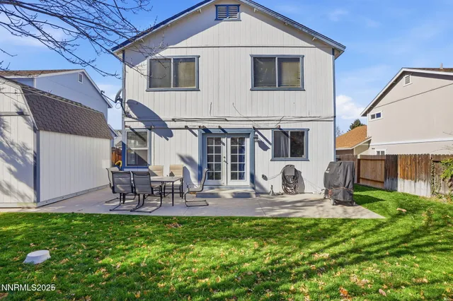 a front view of house with a garden and patio