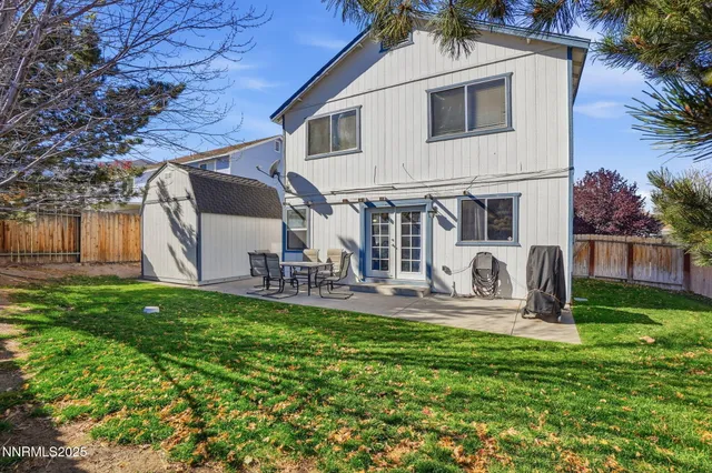 a view of a house with backyard and sitting area