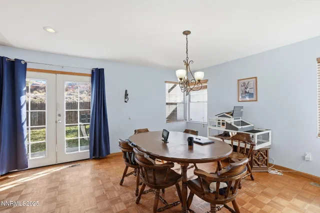 a view of a dining room with a table and chairs