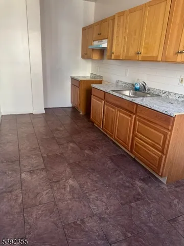 a view of a kitchen with a sink and cabinets