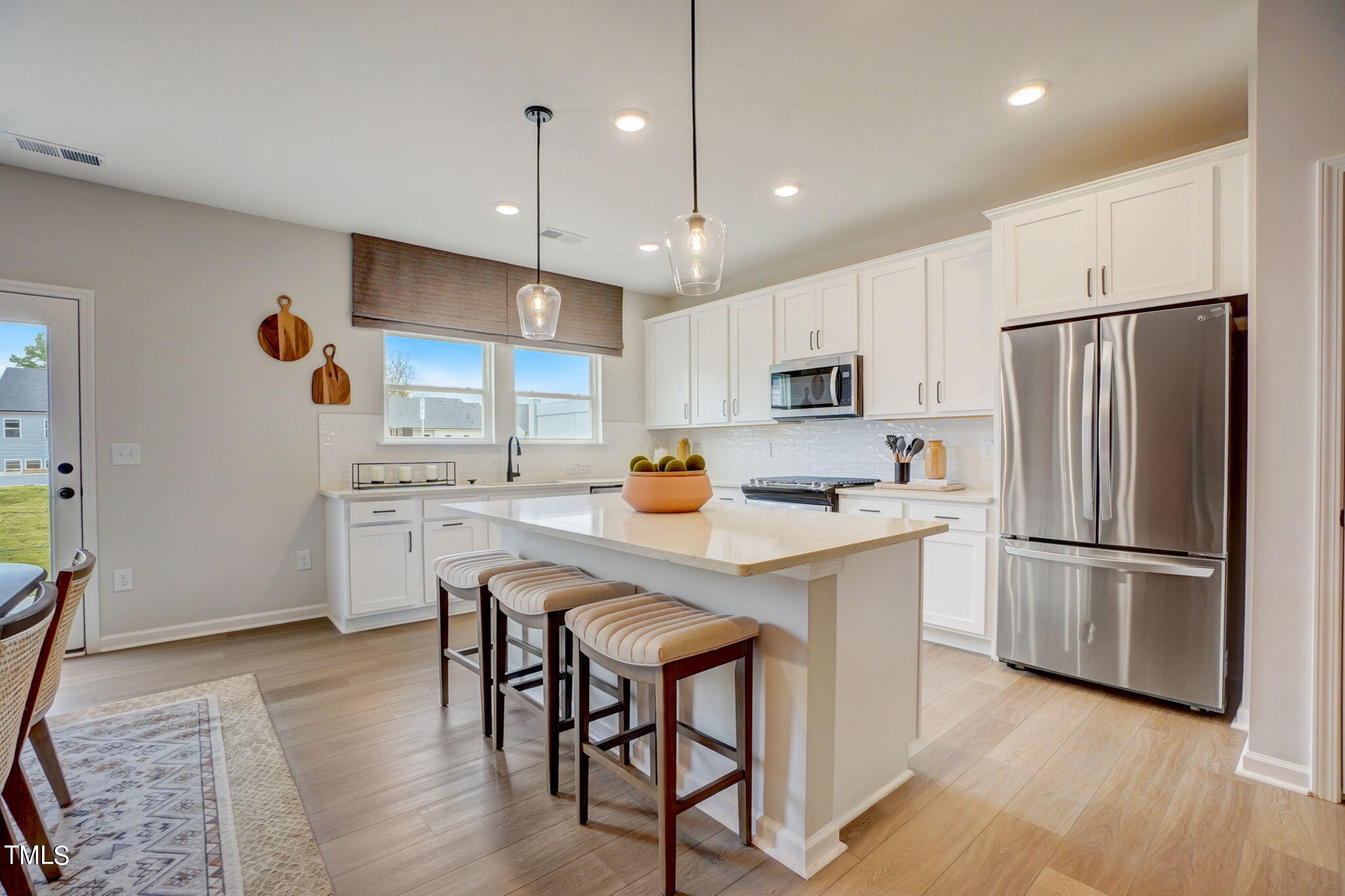 3119 Ranger Drive, Unit 39 Durham, NC 27703 - Photo 4 of 5 a kitchen with white cabinets and stainless steel appliances