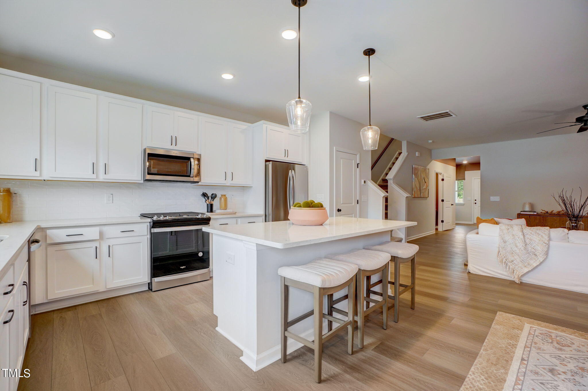 3119 Ranger Drive, Unit 39 Durham, NC 27703 - Photo 5 of 5 a kitchen with stainless steel appliances granite countertop a stove a sink a refrigerator a center island a dining table and chairs