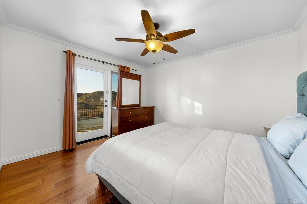 14062 Jamacha Hills Road Jamul, CA 91935 - Photo 16 of 39 a bedroom with a bed and a ceiling fan