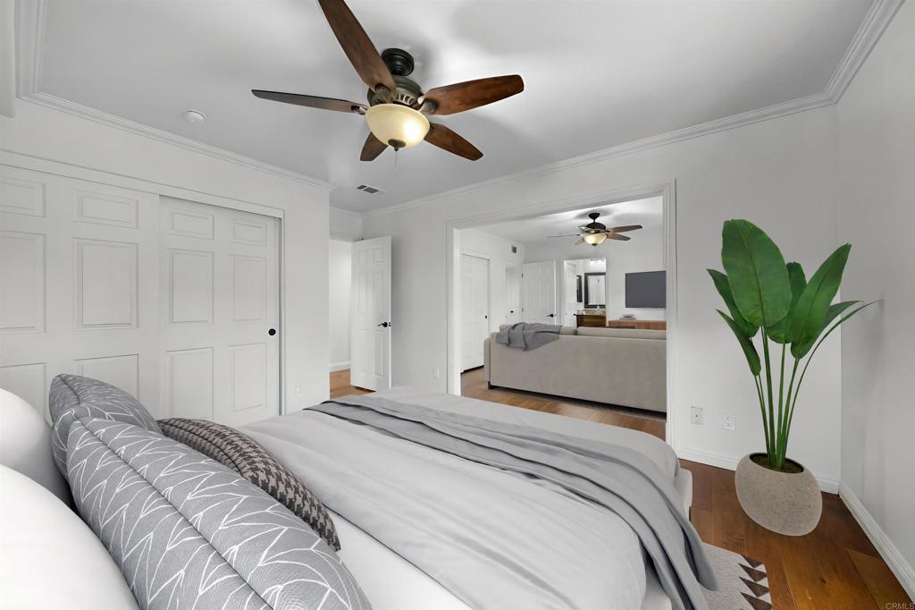 14062 Jamacha Hills Road Jamul, CA 91935 - Photo 18 of 39 a bedroom with a bed a chandelier and a potted plant
