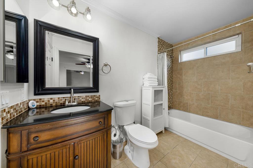 14062 Jamacha Hills Road Jamul, CA 91935 - Photo 20 of 39 a bathroom with a granite countertop sink toilet a mirror and shower