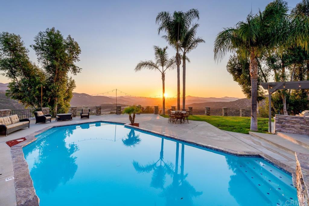 14062 Jamacha Hills Road Jamul, CA 91935 - Photo 28 of 39 a view of a swimming pool with a table and chairs