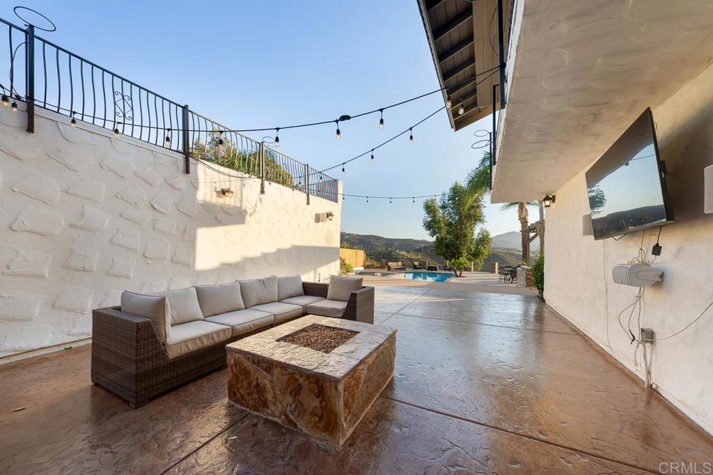 14062 Jamacha Hills Road Jamul, CA 91935 - Photo 31 of 39 a view of a patio with couches and a fire pit with wooden floor