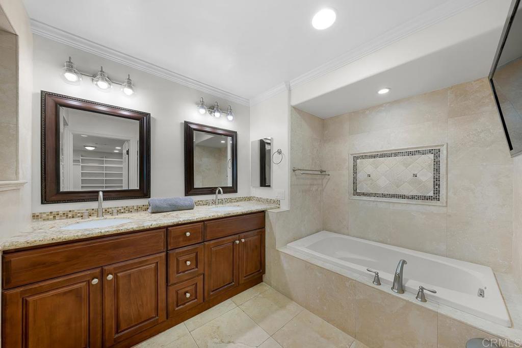 14062 Jamacha Hills Road Jamul, CA 91935 - Photo 9 of 39 a bathroom with a granite countertop double vanity sink a mirror and a bathtub