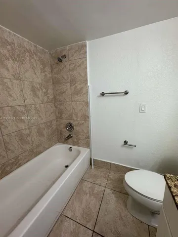 a bathroom with a bathtub and a toilet