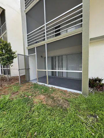 a view of an house with backyard space and balcony